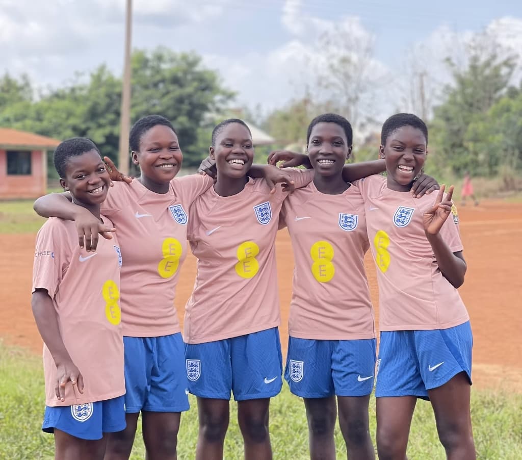 Girls4Goals players smiling in yellow shirts